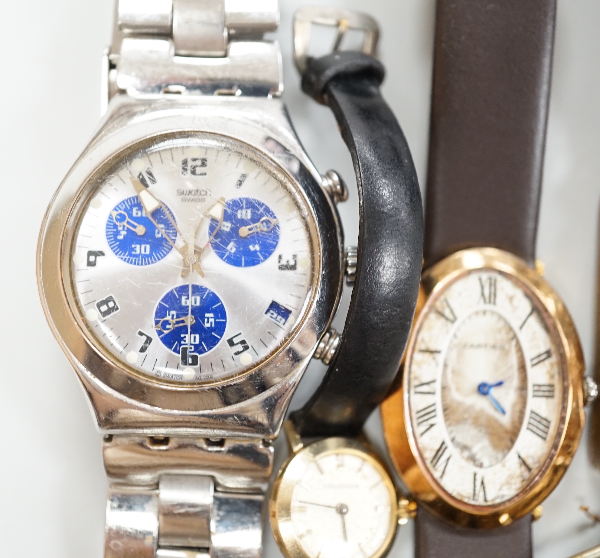 Five gentleman's assorted wrist watches including Swatch and early 20th century white metal and two lady's wrist watches.